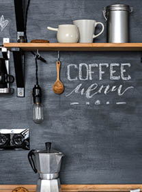 Inscription  Coffee Menu  with chalk on a black wall Kitchens in the style of Loft and Rustic  Geyser coffee maker, wooden shelf, cookies 