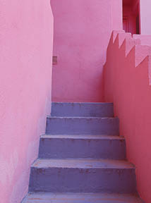 A vertical shot of a building staircase in bright pink and purple colors