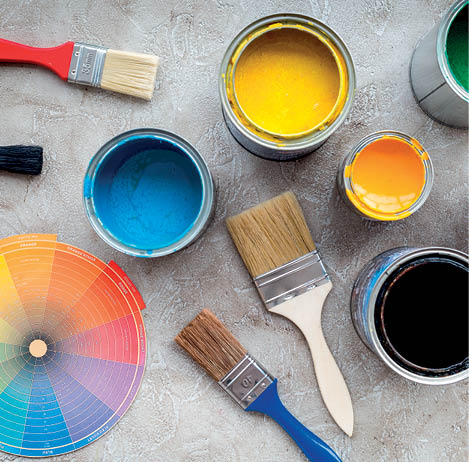 Paints in tin banks and brushes on grey stone background top view