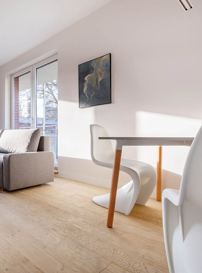 Cozy living room with gray sofa, tv, table and chairs