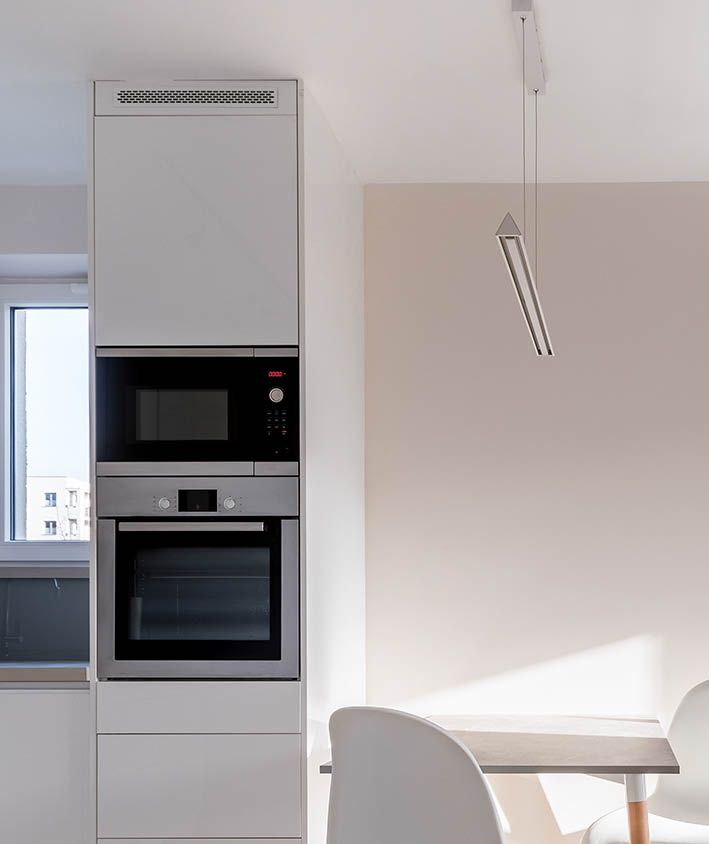 Simple home interior with two white chairs and small dining table