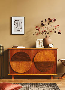 Stylish interior with design wooden commode, stool, dried flowers in vase, unique decoration, carpet, mock up poster frame and elegant personal accessories. Modern living room in classic house.