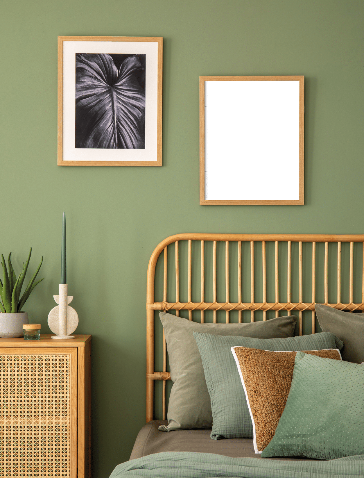 Stylish composition of modern bedroom interior. Mock up poster frames, rattan commode, bed and creative personal accessories. Eucalyptus wall. Template. Copy space. 