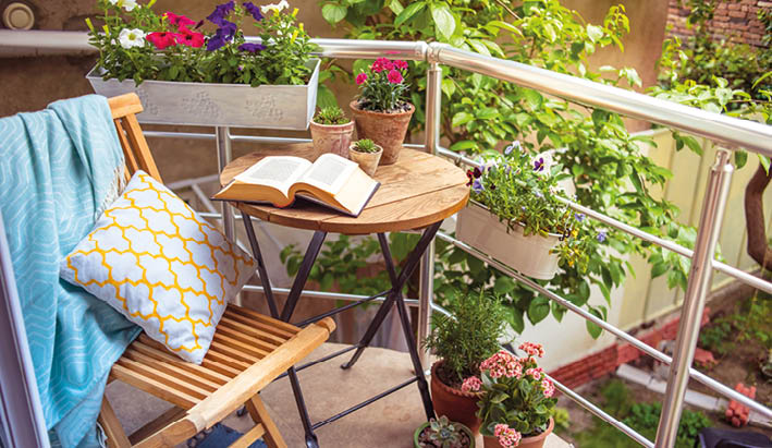 Beautiful terrace or balcony with small table, chair and flowers