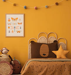 Warm child room interior with mock up poster frame, braided basket, guitar, braided bed, plush lama, monkey, brown bedding, colorful garland and personal accessories. Home decor. Template.