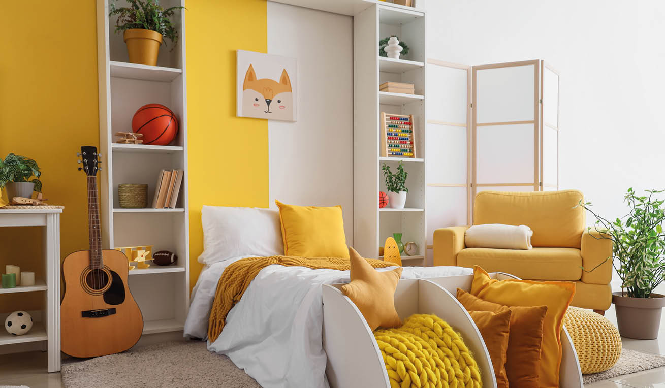 Interior of children's room with bed, shelf units and yellow armchair