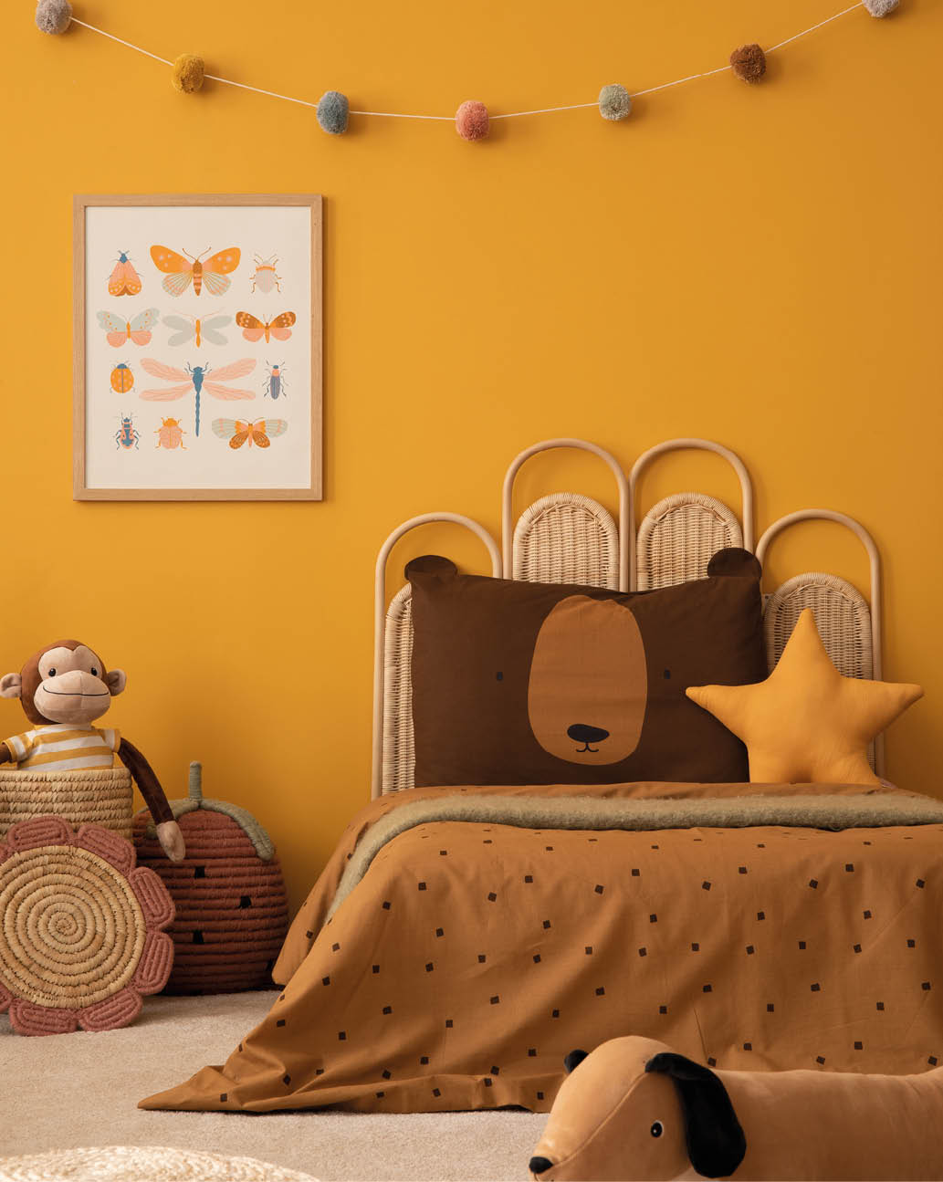 Warm child room interior with mock up poster frame, braided basket, guitar, braided bed, plush lama, monkey, brown bedding, colorful garland and personal accessories. Home decor. Template.