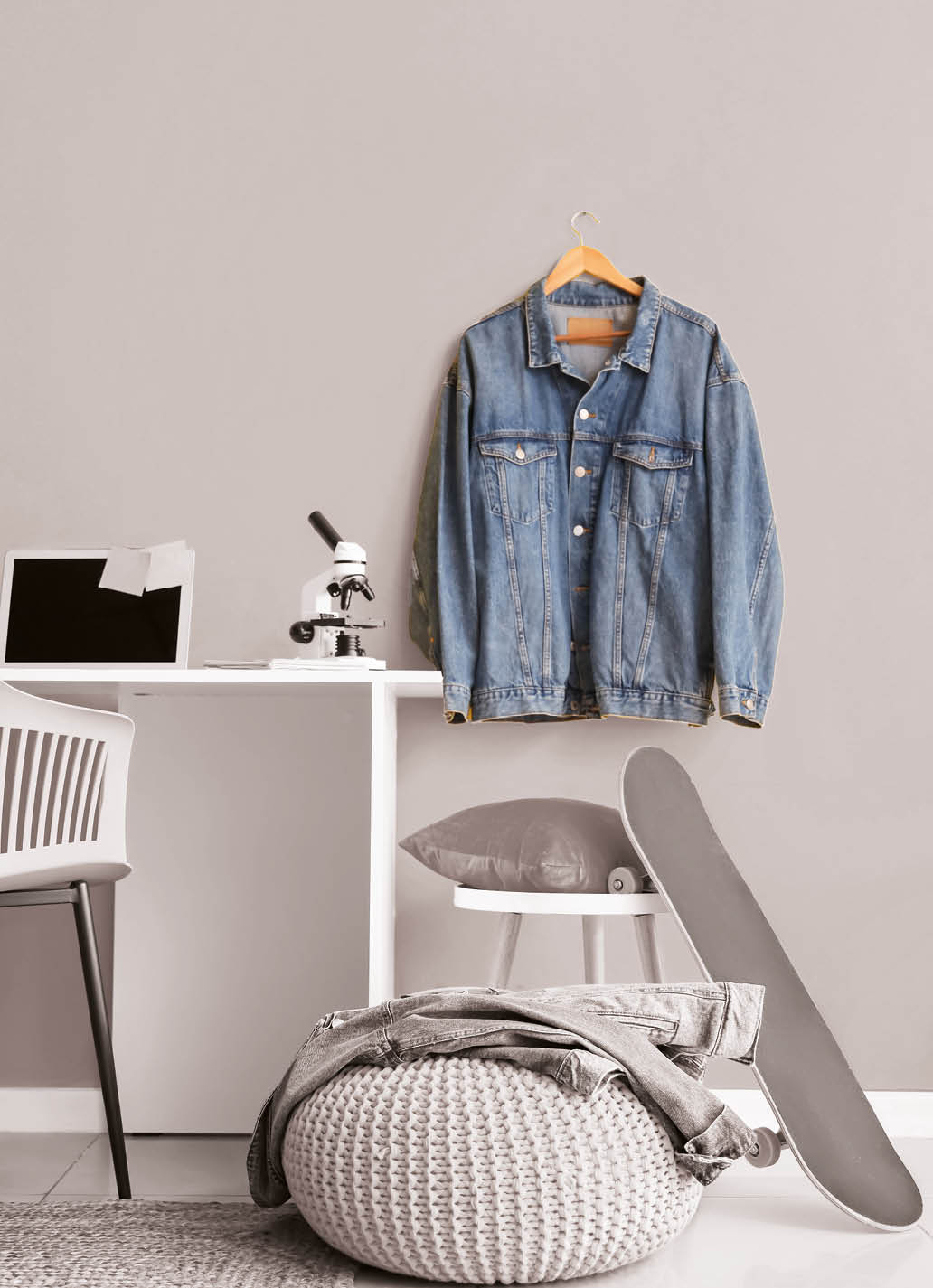 Interior of teenager's room with laptop and microscope on table
