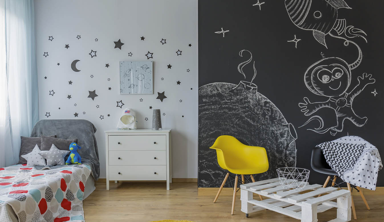 Light child room with single bed, star wall decor blackboard wall