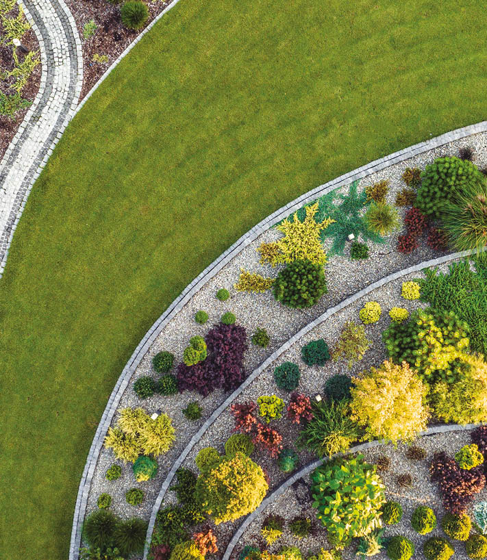 Aerial View of a Large Moden Residential Backyard Garden with Granite Brick Paths, Bench and Large Stairs. 