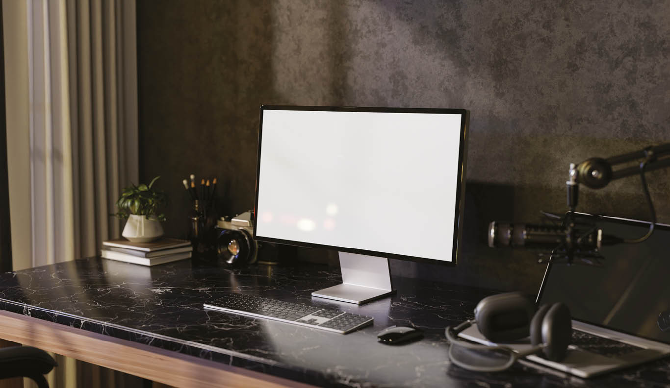 A modern freelance podcaster office workspace featuring a computer with a white screen mockup, headphones, and a microphone on a black marble table against the loft wall. 3d render, 3d illustration