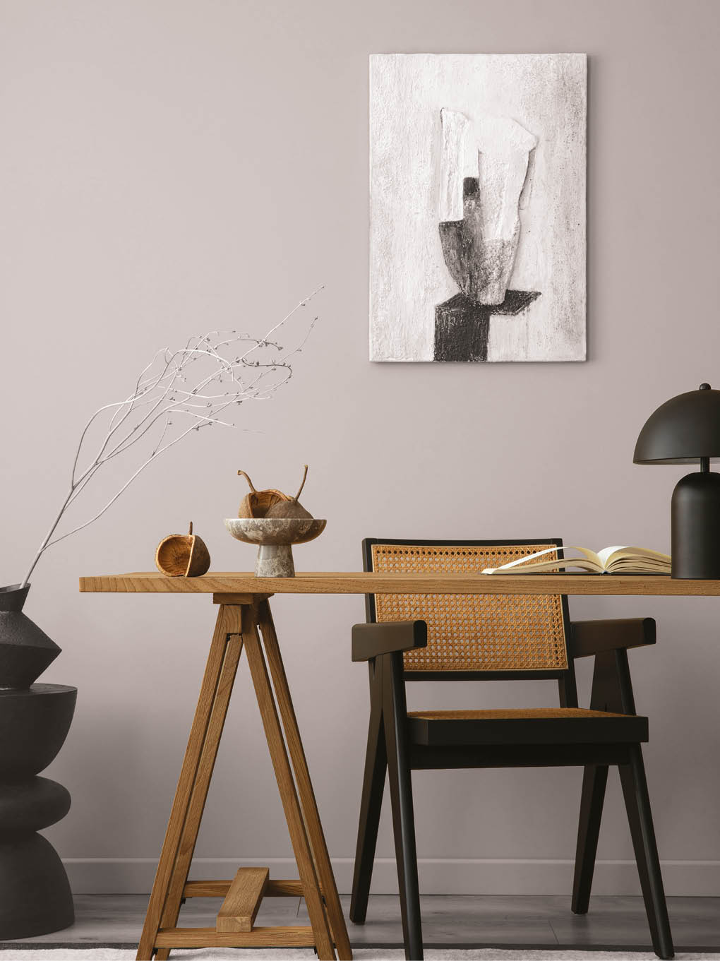 Cozy composition of workplace interior space with mock up poster frame, wooden desk, rattan chair, black lamp, books, patterned carpet, marble bowl and personal accessories. Home decor. Template.